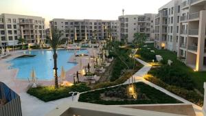 an aerial view of a swimming pool in a resort at Chalet in the marassi marina 2 in El Alamein