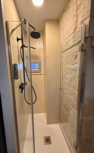 a shower with a glass door in a bathroom at Dimora n 9 in Locorotondo +6 photos