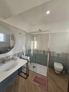 a bathroom with a sink and a shower and a toilet at Acquamarina in Sant'Agnello +16 photos