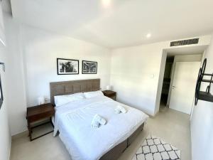 a bedroom with a bed with two towels on it at higuerón Aqualis in Torremuelle +16 photos