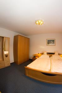 a bedroom with a large bed in a room at Hotel Restaurant Krone in Nassau