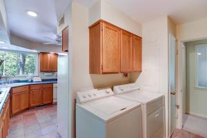 a kitchen with a washer and dryer in it at Woodsy Mountain Home Escape Walk to Marina! in Mountain Home +23 photos