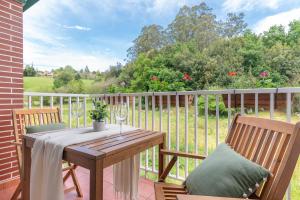 a wooden table and two chairs on a patio at La Casa del Valle de Arce in Puente Arce