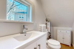 a bathroom with a sink and a toilet and a window at Walker Cottage in Rockport +14 photos