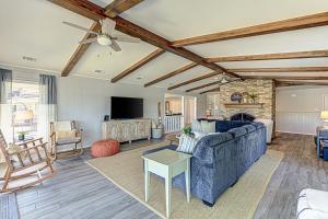 a living room with a blue couch and a fireplace at Two Docks on Riverside in Kingsland