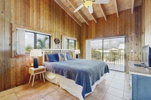 Key Colony BeachにあるGray Pelican Houseの木製の壁の部屋にあるベッドのある寝室