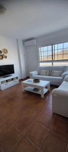 a living room with two couches and a table at Flamingos view apartment in Cabo de Gata in El Pozo del Cabo +20 photos