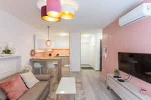 a living room with a couch and a table at Sunset Resort 103 in Fonyód