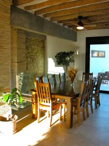 a dining room with a wooden table and chairs at Los Chicos de Lastanosa Hotel y Restaurante in Lastanosa