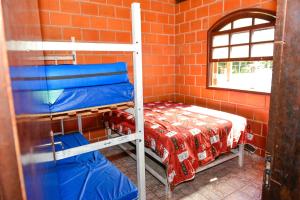 a room with two bunk beds next to a brick wall at CHACARA HORTOLAN in Mairinque +15 photos