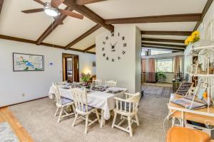 a dining room with a table and a clock on the wall at Peaceful Groveland Home with Deck and Fire Pit! in Groveland
