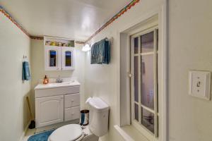 a bathroom with a toilet and a sink at Peaceful Groveland Home with Deck and Fire Pit! in Groveland +37 photos