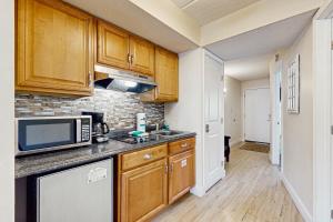 a kitchen with wooden cabinets and a microwave at Mountain Splendor in Gatlinburg +10 photos