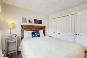 a bedroom with a bed with a blue pillow on it at Mountain Splendor in Gatlinburg