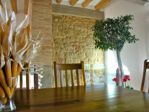 a dining room table with chairs and a vase with flowers at Los Chicos de Lastanosa Hotel y Restaurante in Lastanosa +45 photos