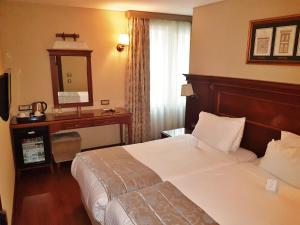 Cama ou camas em um quarto em Hotel Perula & SPA