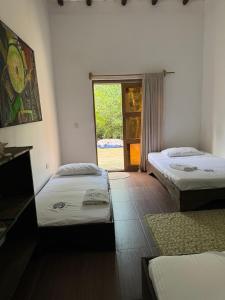 Letto o letti in una camera di Medusa Hostel Isla Tintipan