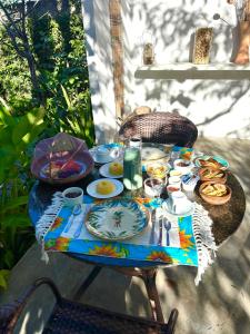 a table with plates of food on top of it at Studio Havaí - Village Capixaba in Gravatá