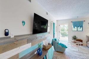 a living room with a flat screen tv on a wall at Hilton Head Resort 4313 in Hilton Head Island