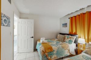 a bedroom with a bed and orange curtains at Hilton Head Resort 4313 in Hilton Head Island +40 photos