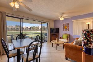 a living room with a couch and a table and chairs at La Costa Villa 2 Depto 202 in San José del Cabo