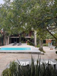 a swimming pool in a yard with trees at Suite 4 - Village Capixaba in Gravatá
