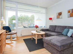 a living room with a couch and a table at 4 person holiday home on holiday park in Glesborg in Glesborg