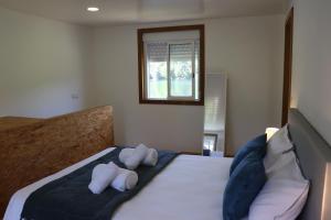 a bedroom with two stuffed animals on a bed at Casa do Vouga in Oliveira de Frades +28 photos
