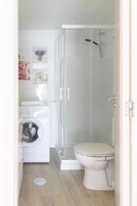 a white bathroom with a toilet and a shower at Flowers & Beach Oporto House in Valadares +19 photos