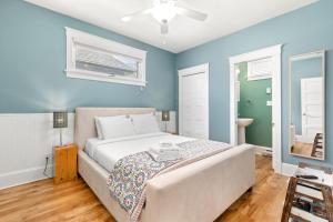 a bedroom with blue walls and a bed in it at The Hemlock - 1 Hollow in Cherry Valley