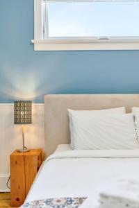 a bedroom with a white bed and a window at The Hemlock - 1 Hollow in Cherry Valley