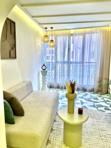 a living room with a couch and a table at Eden Vibes GUELIZ in Marrakech +14 photos