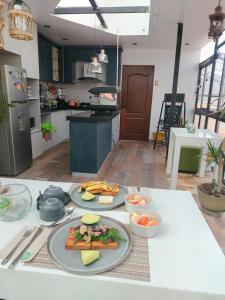 a kitchen with two plates of food on a table at Departamento con súper desayuno in Cusco