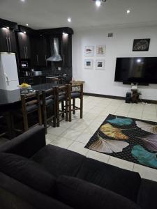 a living room with a couch and a dining room at Oasiselfcatering guest house in Vosburg +11 photos
