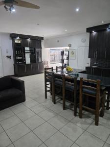 a kitchen with a table and chairs in a room at Oasiselfcatering guest house in Vosburg