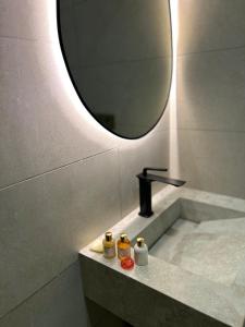 a bathroom with a sink and a mirror at Eden Vibes GUELIZ in Marrakech