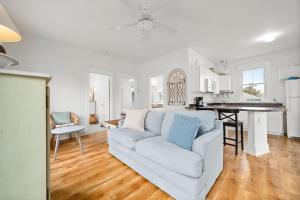 a living room with a white couch and a kitchen at The Willow - 20 Butternut in Cherry Valley