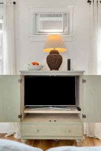 a television on a stand with a lamp on top at The Willow - 20 Butternut in Cherry Valley