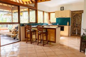 a kitchen with a island with bar stools at Riveresque in Margaret River Town