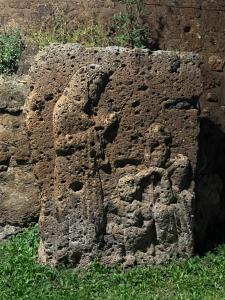 a stone sculpture of a face on a wall at Rome Countryside Luxury Villa Casale Centocorvi con parco e piscina in Marina di Cerveteri