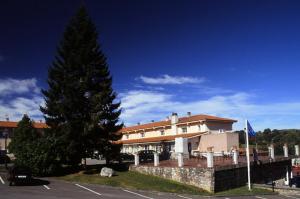 un grand bâtiment avec un arbre en face dans l'établissement Hotel Villa De Nava, à Nava