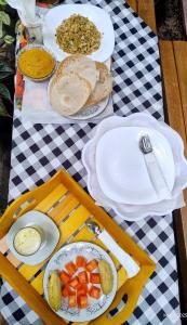 a table with plates of food on a picnic table at DKC Apartment in Ahangama +38 photos
