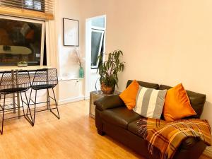 a living room with a couch and a table at Bude A2 - CosySaver in Belle Isle