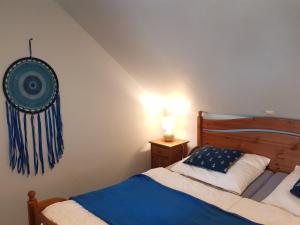 a bedroom with a bed and a wall with a flag on the wall at Blaues Strandhaus Hinter der Düne - Erste Reihe - Strand Ückeritz in Ueckeritz +24 photos