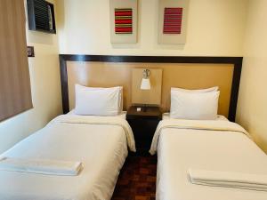 Postel nebo postele na pokoji v ubytování Baguio Holiday Villas