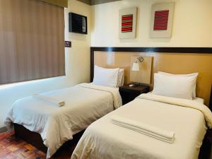 Postel nebo postele na pokoji v ubytování Baguio Holiday Villas