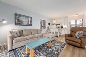 a living room with a couch and a table at Driftwood Dreams 1B in Traverse City