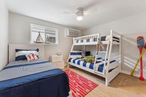 a bedroom with two bunk beds and a ladder at North Wind Motel in North Wildwood