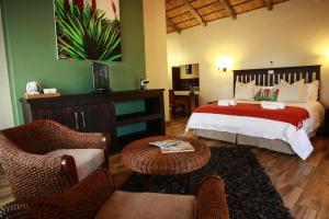 a bedroom with a bed and a living room at Woodlands Guest House in Hazyview +35 photos