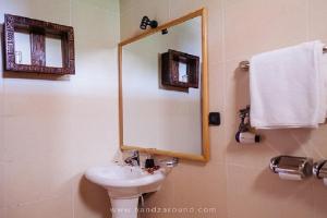 a bathroom with a sink and a mirror at Maribela Hotel in Lalībela